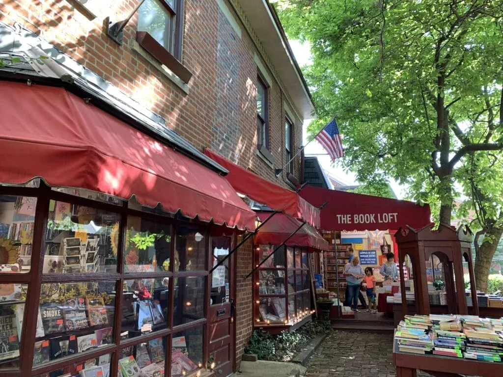 outside of a book shop with a big red awning 