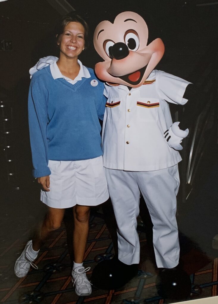 Disney Cruise Line crew member with Mickey Mouse