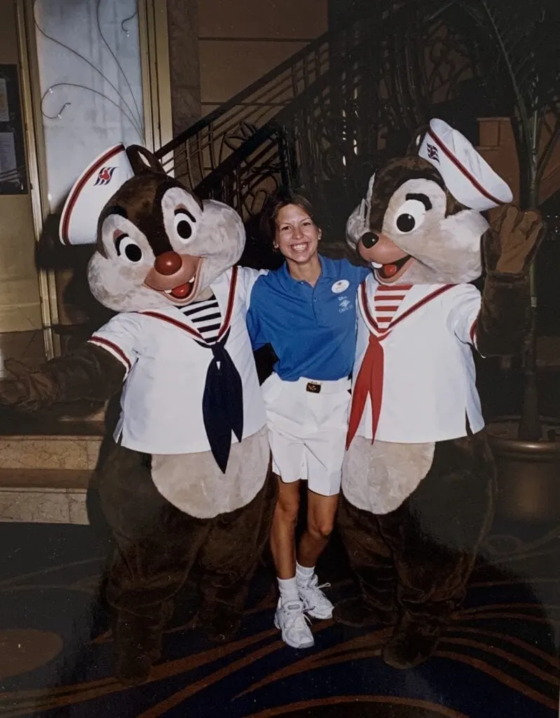 woman standing with Chip and Dale characters onboard cruise ship