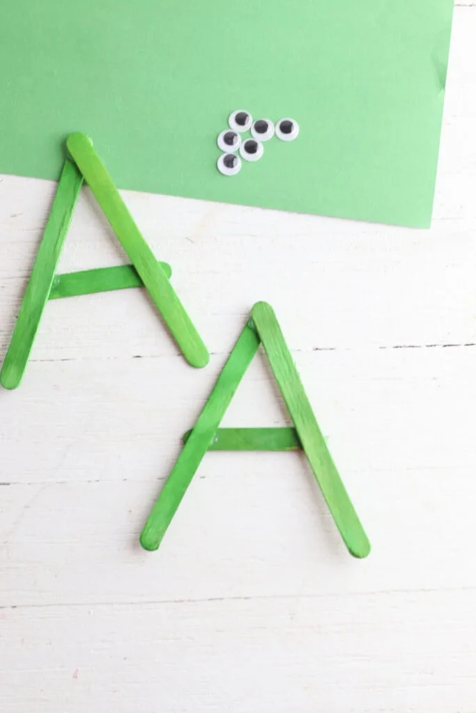 A shape made from green popsicle sticks
