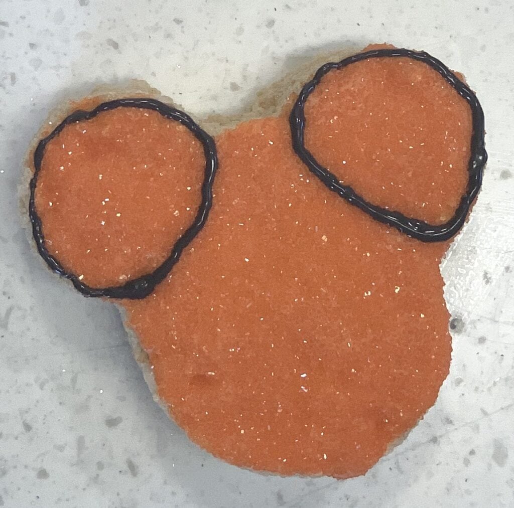 black icing drawn in circles around mouse ears