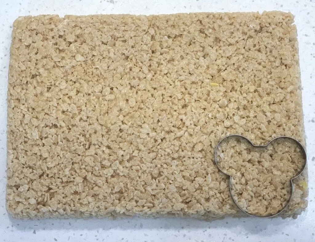 Mickey Mouse shaped cookie cutter on rice krispy treats 
