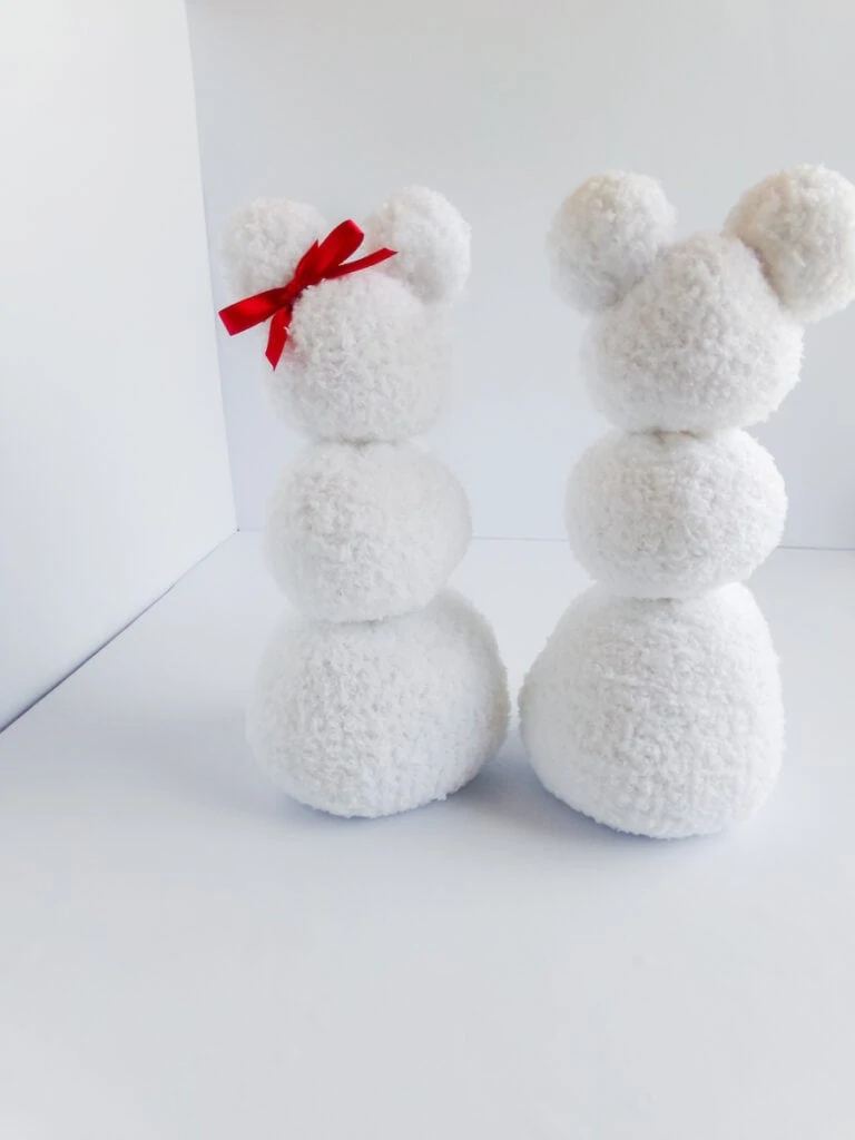 two white sock snow people with white background 