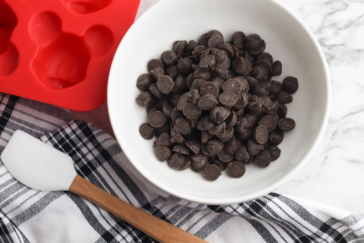 bowl of chocolate chips next to spatula