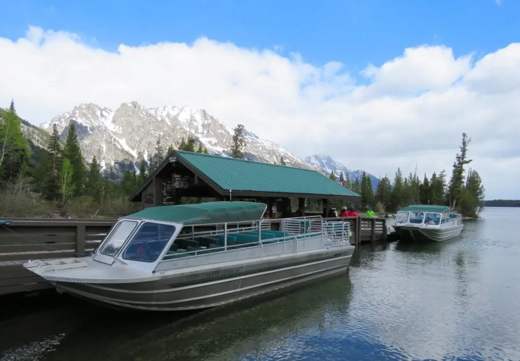 two boats in lake near a boat dock in Grand Teton National Park