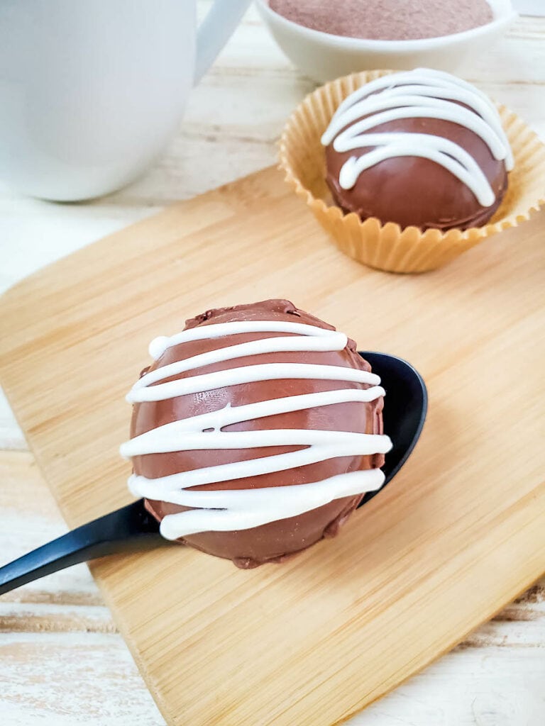 Spiced Rum Hot Chocolate Bombs on spoon