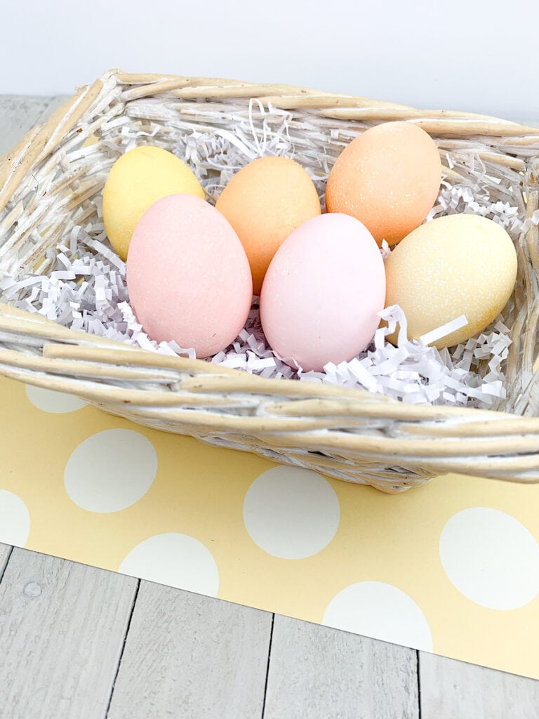 pastel colored Easter Eggs in basket on table