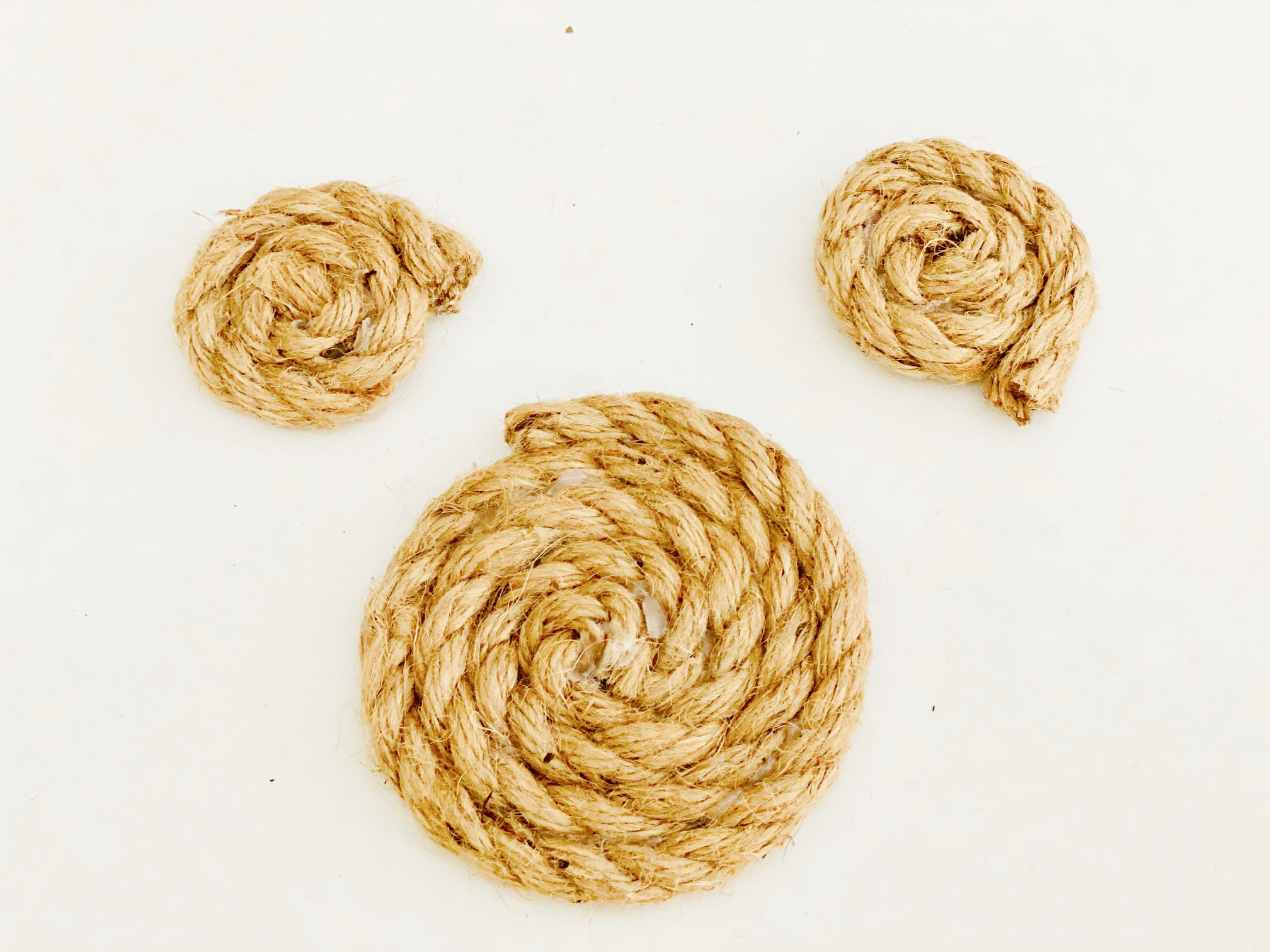three coiled circles of rope in different sizes on white background
