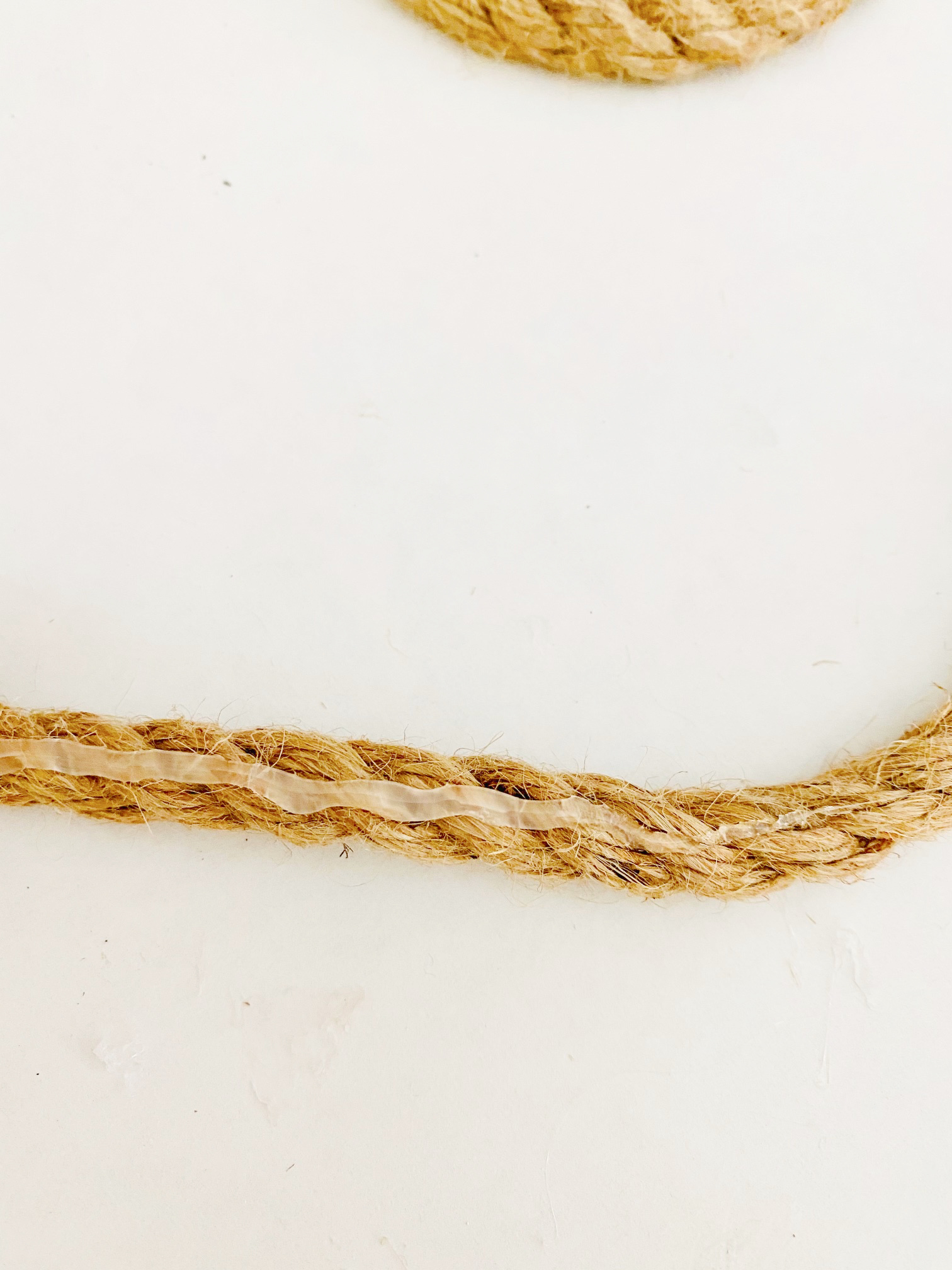 line of hot glue on a piece of jute rope