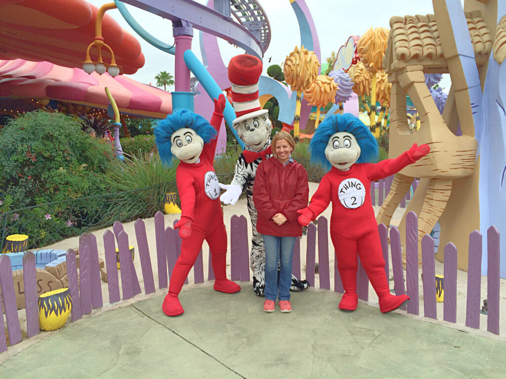 woman posing with Dr. Seuss characters at Universal theme park