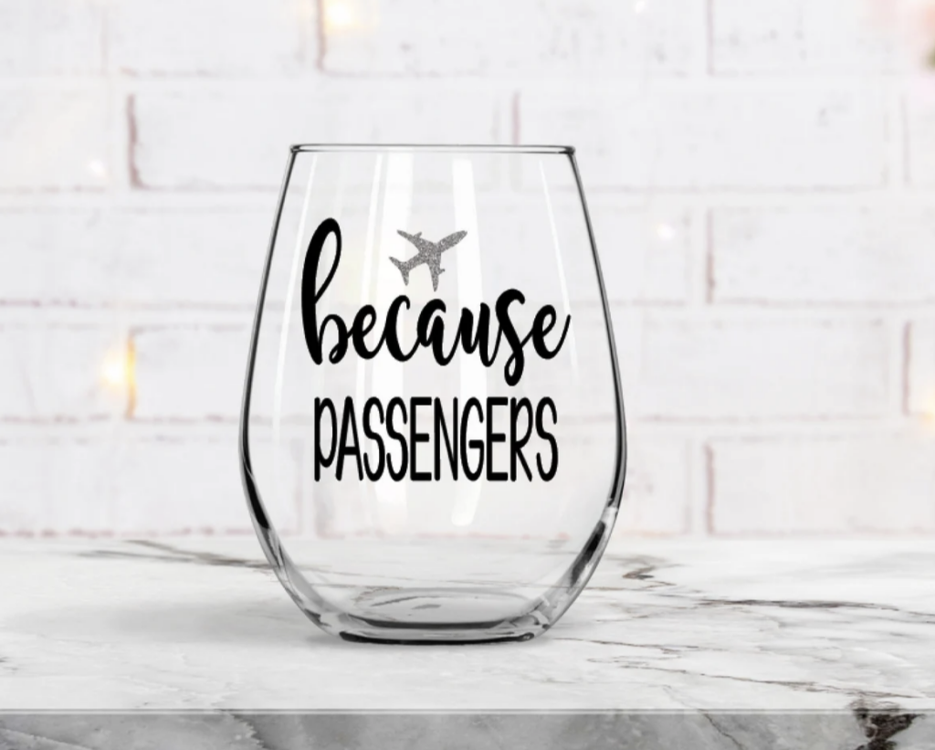clear wine glass with saying Because Passengers