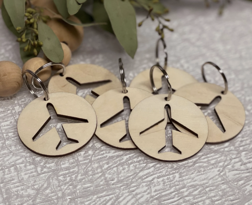 wooden key chains with airplane cut outs in the middle
