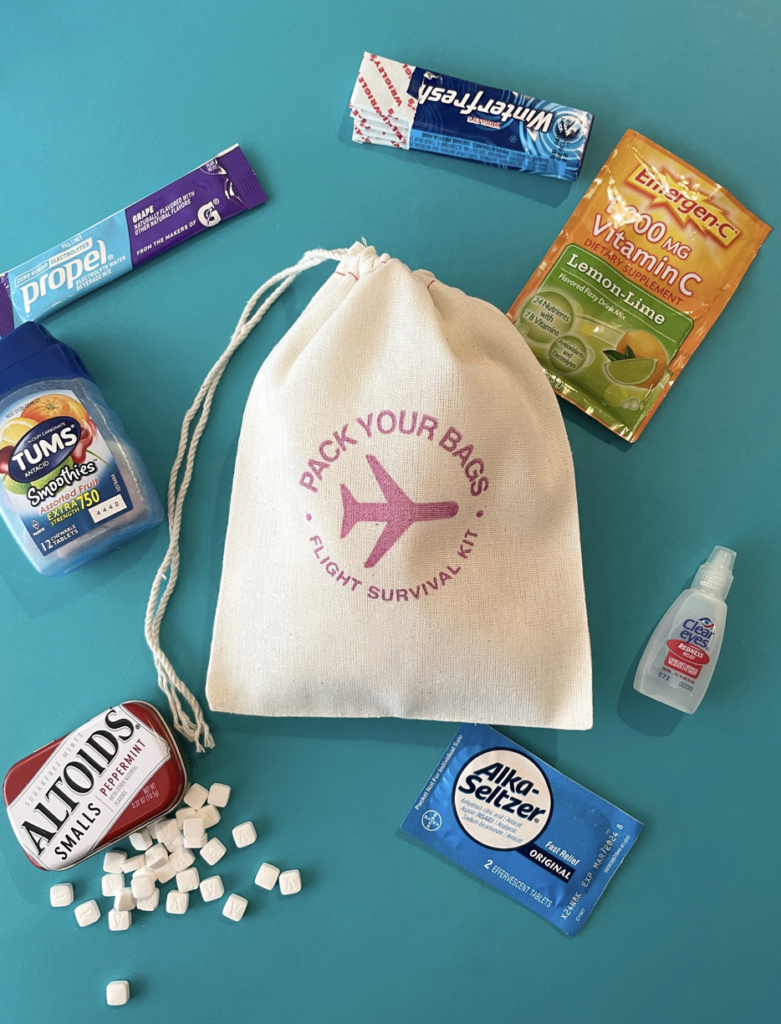 mini canvas drawstring bag with flight amenities surrounding it