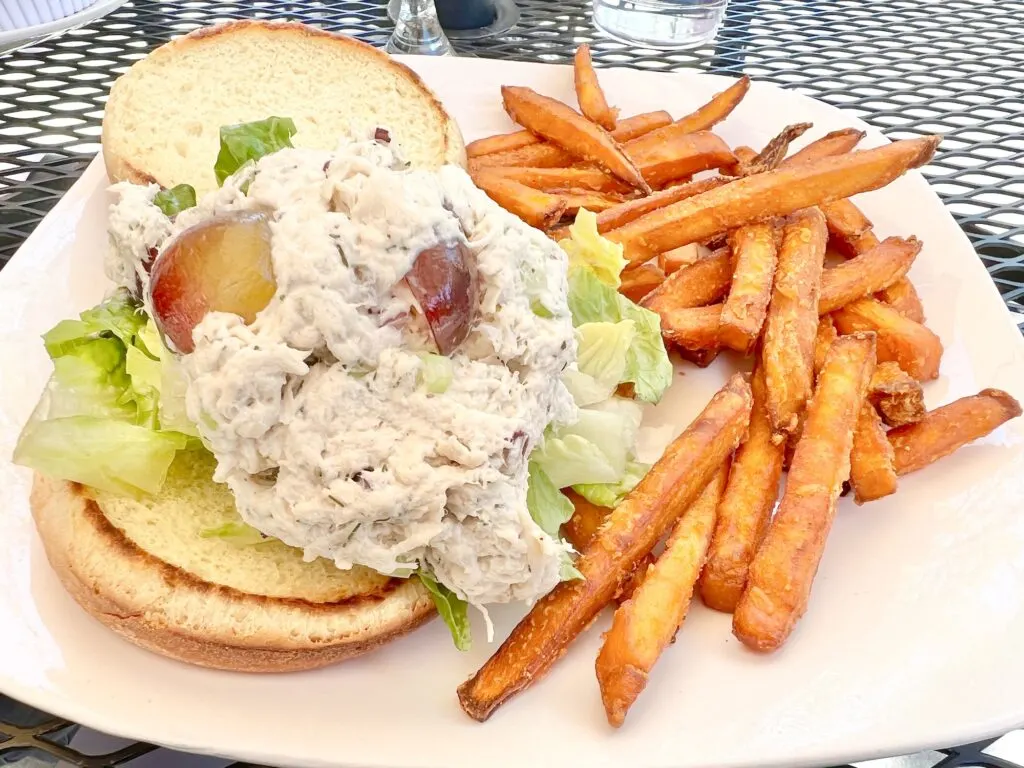 chicken salad sandwich and sweet potato fries on a plate