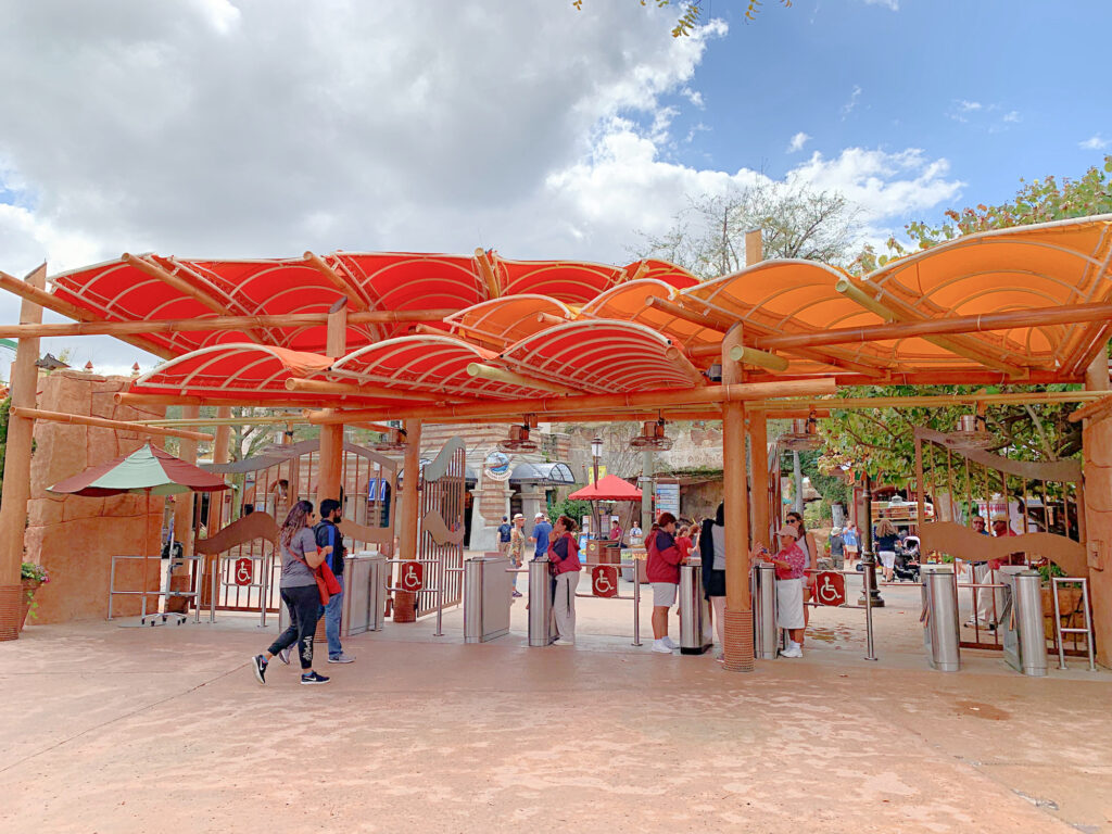 entrance to Islands of Adventure theme park with shade canopies over ticket booths