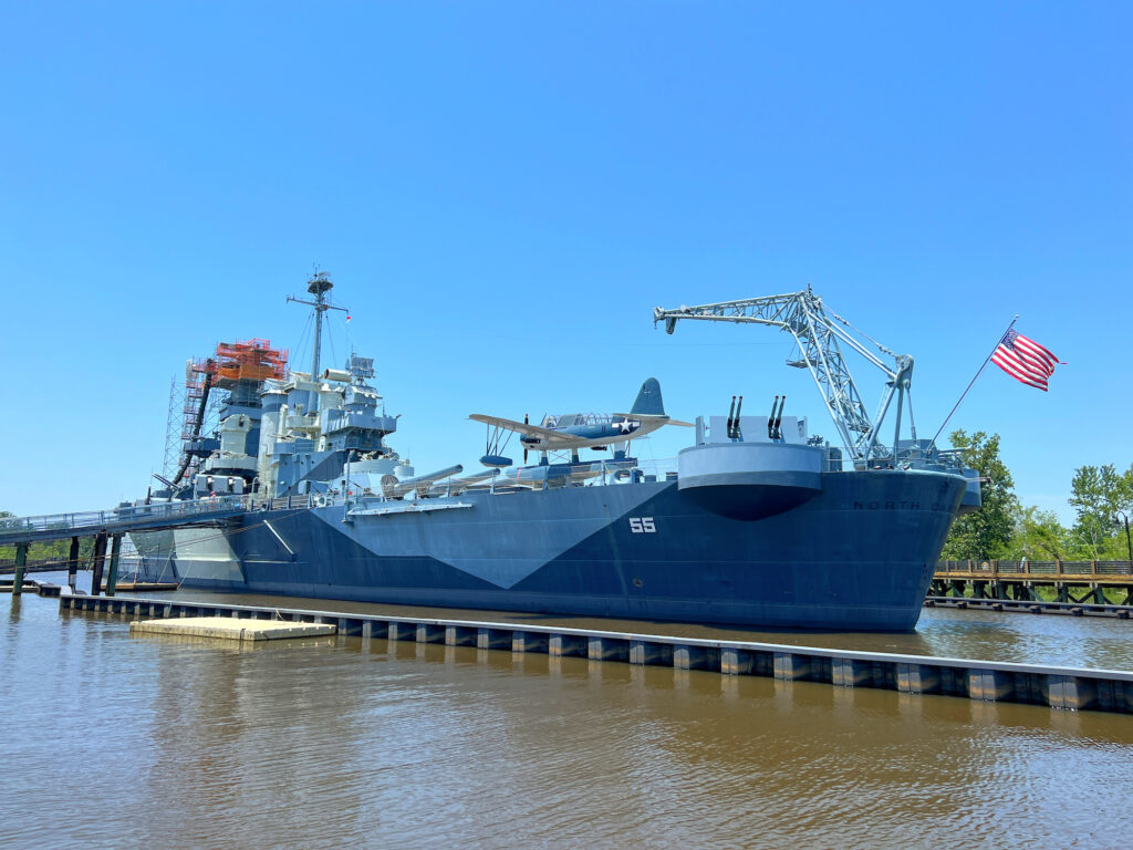 exterior full length view of USS Battleship North Carolina in water
