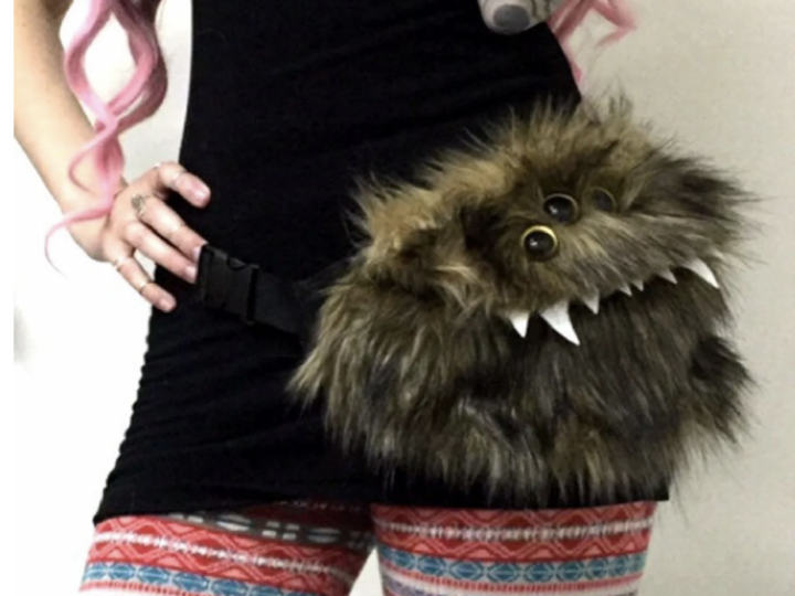 woman wearing a fuzzy monster hip bag