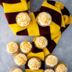 Harry Potter inspired butterbeer cupcakes displayed on a Gryffindor scarf