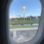 Orlando Airport tower and runway seen from an airplane window