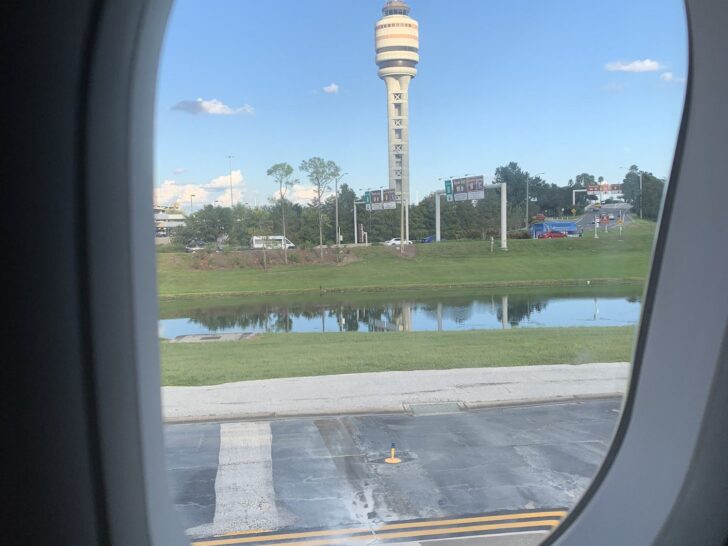 Orlando Airport tower and runway seen from an airplane window