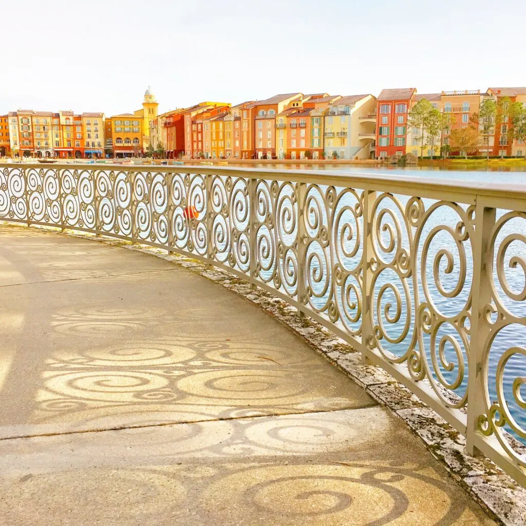 decorative railing casting shadows on walkway towards Universal Studios Portofino Bay Hotel