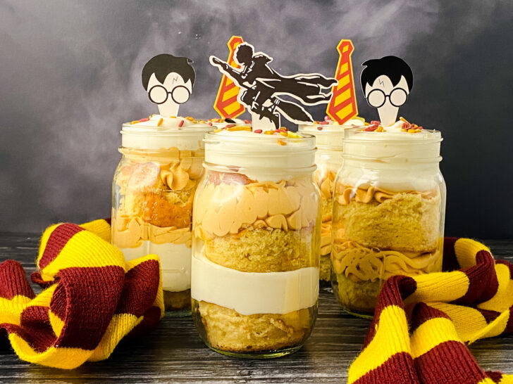 butterbeer cake jars in mason jars with Harry Potter cake decorations on top