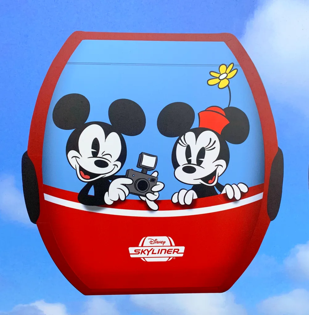 mickey and Minnie Mouse in Disney skyline car against blue sky