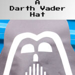 Darth vader hat made out of construction paper on a child's head
