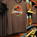 brown t-shirt with jurassic park logo hanging in universal studios gift shop