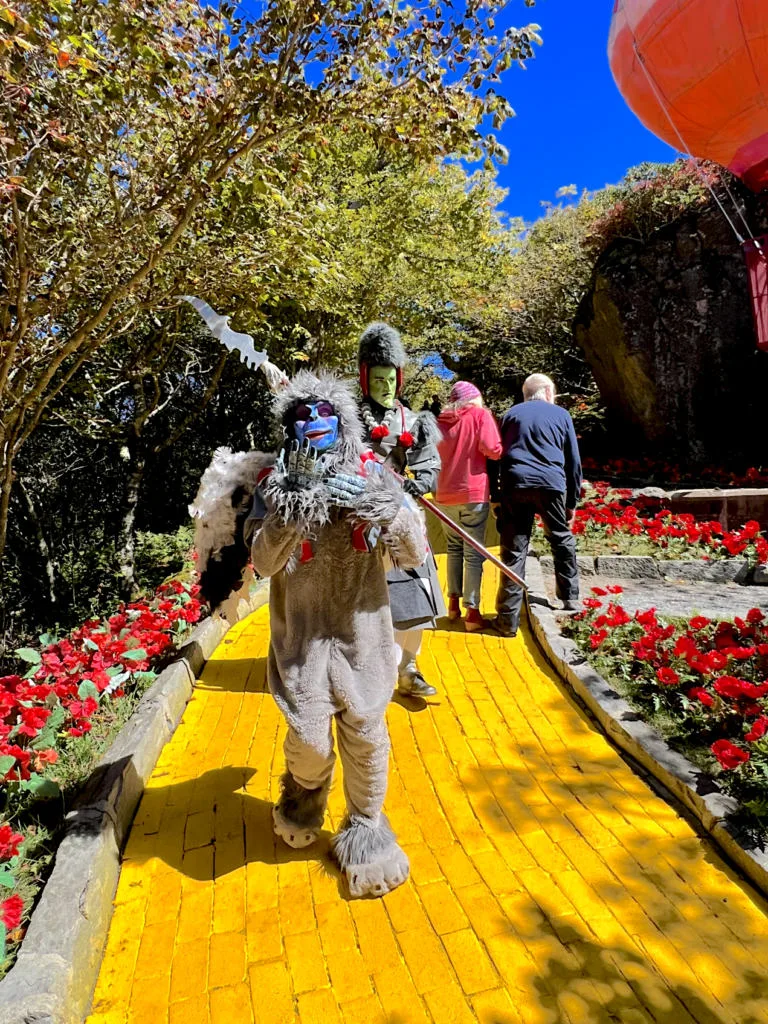 Land of Oz Theme Park with Flying Monkey and Royal Guard on Yellow Brick Road