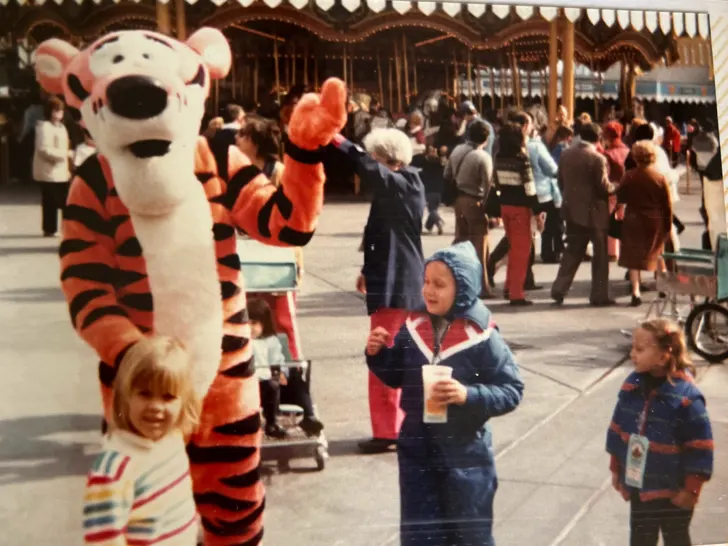 vintage photo of kids with Tigger at Magic Kingdom in front of carousel