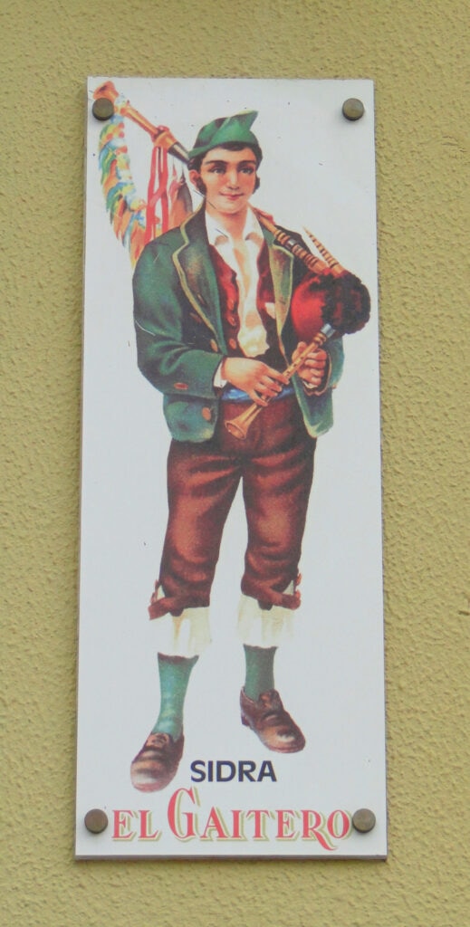 A sign featuring a bagpipe player in Asturias, Spain.