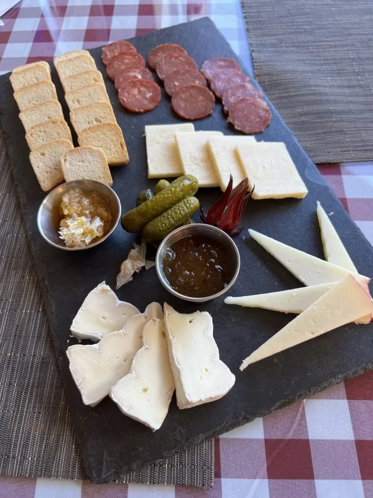 The Henderson set out a platter of meats and cheeses on a table.