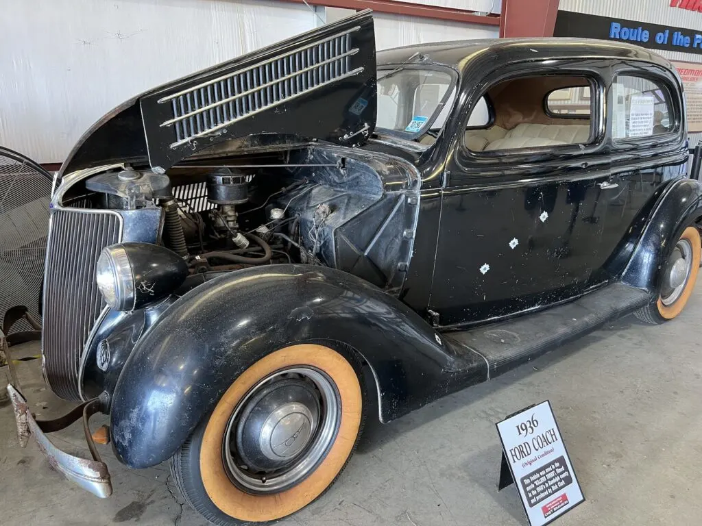 An old black car with its hood open, featured in movies filmed in North Carolina.