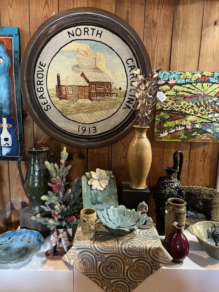 A display of pottery and other items in a store, perfect for those looking for interesting things to do in Asheboro.