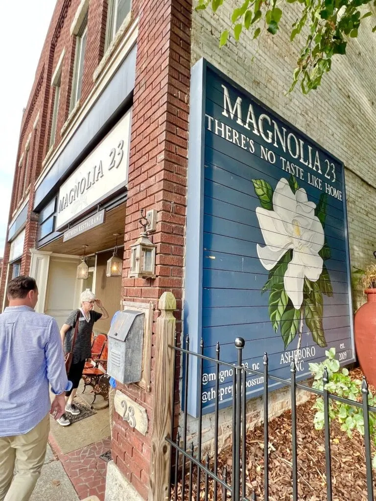 Looking for things to do in Asheboro? Look no further than Magnolia & Thomas, a charming brick building with a sign that says "Magnolia & Tho".