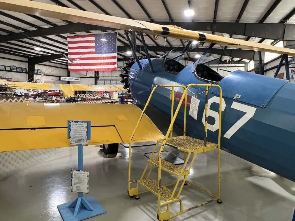 Located in an Asheboro hangar, visitors can find a vibrant blue and yellow biplane showcased for all to see.